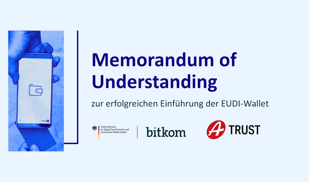 Grafik mit der Überschrift 'Memorandum of Understanding zur erfolgreichen Einführung der EUDI-Wallet'. Links hält eine Hand ein Smartphone mit einem Wallet-Symbol auf dem Bildschirm. Unten stehen die Logos des Bundesministeriums für Digital Transformation und Government Modernisation, von Bitkom und A-Trust. 